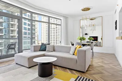 a living room with a couch and a table at VayK - Exquisite 2BR with Panoramic Marina View in Dubai