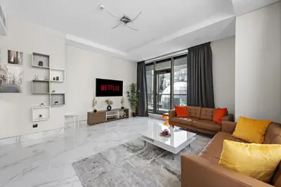 a living room with a couch and a table at Vayk - Spacious and Vibrant 2BR Apartment in Business Bay in Dubai