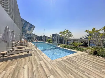 a swimming pool on the side of a building at Vayk - Spacious and Vibrant 2BR Apartment in Business Bay in Dubai