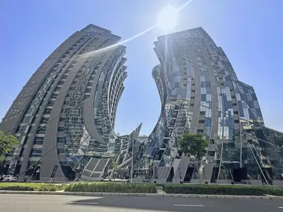 two tall buildings with the reflection of the sky at Vayk - Spacious and Vibrant 2BR Apartment in Business Bay in Dubai