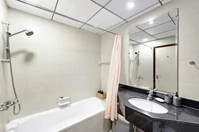 a bathroom with a sink and a tub and a mirror at VayK - Welcoming and Warm 2BR in JLT in Dubai