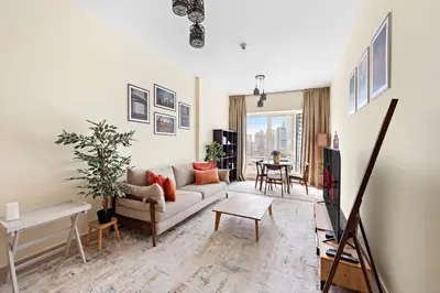 a living room with a couch and a table at VayK - Welcoming and Warm 2BR in JLT in Dubai