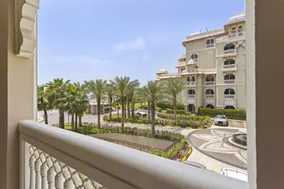 a balcony with a view of a street and palm trees at VayK - Stylish 1BR in Palm Jumeirah with Secluded Beach Access in Dubai