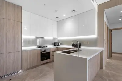 a kitchen with a sink and a stove top oven at Elevated 2 Bedroom with Khalifa view in Peninsula in Dubai