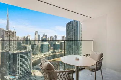 a dining room with a view of the city at Elevated 2 Bedroom with Khalifa view in Peninsula in Dubai