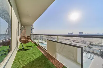 a balcony with a view of an airport at Chic 1BR Getaway in Tulip Oasis 9 Majan in Dubai
