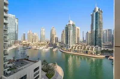 a view of a river in a city with tall buildings at VayK - Chic Marina-Front 1BR in a Luxurious Location in Dubai
