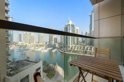 a balcony with a bench and a view of a harbor at VayK - Chic Marina-Front 1BR in a Luxurious Location in Dubai