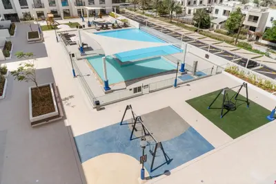 an overhead view of a swimming pool at a building at VayK - Chic 2BR in Town Square with Pool View in Dubai