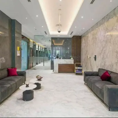 a lobby with couches and a table in a building at Heart of Downtown Luxury 1BHK Dunya in Dubai