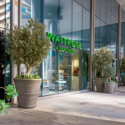 a building with three large potted trees in front of a store at Heart of Downtown Luxury 1BHK Dunya in Dubai