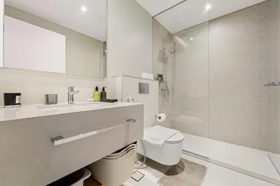 a bathroom with a toilet and a sink and a shower at VayK - Feel the Festive Vibe in Cozy 1BR with Beach Access in Dubai
