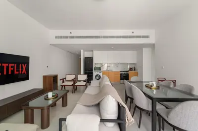 a living room with a couch and a table at VayK - Feel the Festive Vibe in Cozy 1BR with Beach Access in Dubai