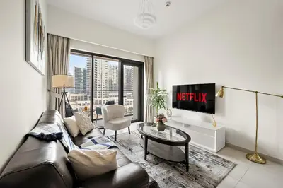 a living room with a couch and a table at VayK - Iconic 1BR in Downtown in Dubai
