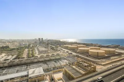 an aerial view of a factory with the ocean in the background at VayK - Bright and Stylish 1BR in Marina in Dubai