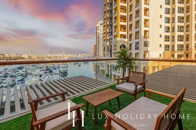 a balcony with chairs and a view of a marina at LUX The Palm Sea View Studio in Dubai