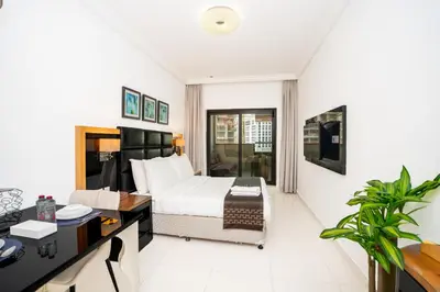 a hotel room with a bed and a desk at Escape24 Cozy Studio at Capital Bay near Burj Khalifa in Dubai