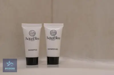 two bottles of ayurkiss sunscreen sitting on a counter at Luxury Spacious 1BR JVC 2Bath Pool Gym in Dubai