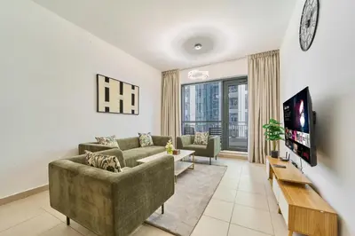 a living room with a couch and a tv at Golden Homes Aqua Bay 1BR-BLVD CENTRAL Downtown Dubai mall in Dubai