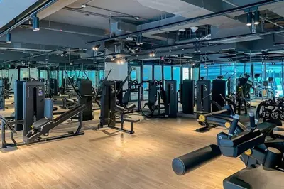 a gym with lots of treadmills and machines at HAVN- 1 Bedroom in Binghatti, Al Jaddaf in Dubai