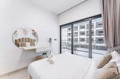 a bedroom with a bed and a large window at HAVN- 1 Bedroom in Binghatti, Al Jaddaf in Dubai