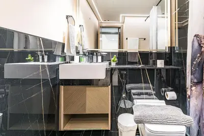 a bathroom with two sinks and two toilets at HAVN- 1 Bedroom in Binghatti, Al Jaddaf in Dubai