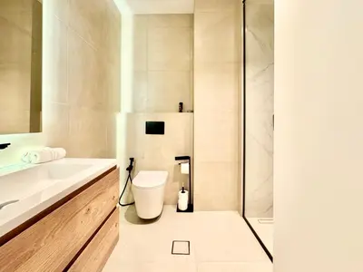 a bathroom with a toilet and a sink at Luxury Studio Apartment Near Jumeirah Beach in Dubai