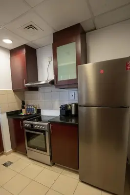 a kitchen with a stainless steel refrigerator and cabinets at Airstay - Stunning 2BR Marina View Retreat - JBR - Monthly Offer Available! in Dubai