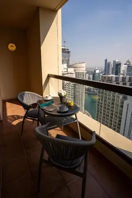 a balcony with a table and chairs and a view of a city at Airstay - Stunning 2BR Marina View Retreat - JBR - Monthly Offer Available! in Dubai