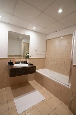 a bathroom with a sink and a tub and a mirror at Airstay - Stunning 2BR Marina View Retreat - JBR - Monthly Offer Available! in Dubai