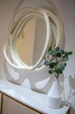a white vase with a plant in front of a mirror at Airstay - Stunning 2BR Marina View Retreat - JBR - Monthly Offer Available! in Dubai