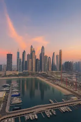 a view of a city with boats in a harbor at Marina Vista 2BR High Floor Sea View Emaar Beachfront in Dubai
