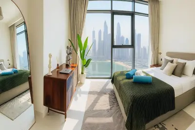 a bedroom with a bed and a large window at Marina Vista 2BR High Floor Sea View Emaar Beachfront in Dubai