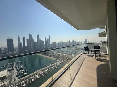 a balcony with a view of a city at Marina Vista 2BR High Floor Sea View Emaar Beachfront in Dubai