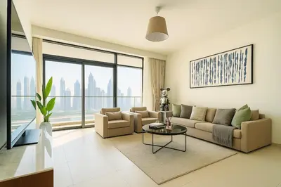 a living room with a couch and a table at Marina Vista 2BR High Floor Sea View Emaar Beachfront in Dubai
