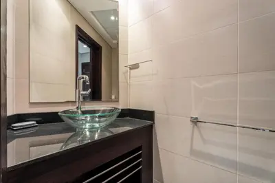 a bathroom with a sink and a mirror at GuestReady - 2BR l Marina View + Infinity Pool in Dubai