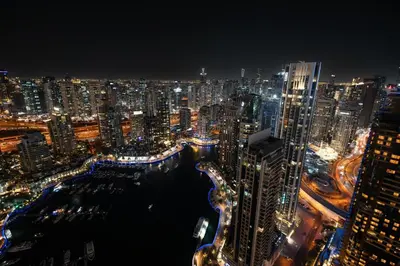 a view of a city at night at GuestReady - 2BR l Marina View + Infinity Pool in Dubai