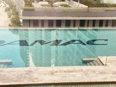 a swimming pool with a painting on the side of a building at Premium Guest - Majestine Downtown Luxe in Dubai