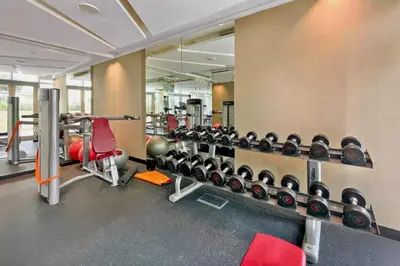 a fitness room with a row of dumbbells in a gym at Premium Guest - Majestine Downtown Luxe in Dubai