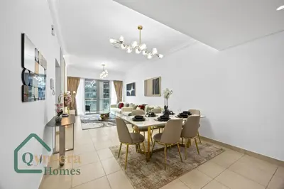 a dining room and living room with a table and chairs at Skyline Bliss Luxury Apartment Dubai in Dubai