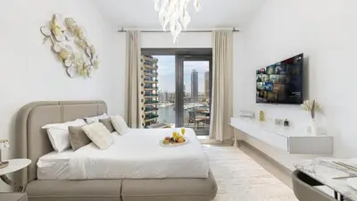 a white bedroom with a bed and a large window at Sparkle Tower by Swarovski, Premium Full Marina View, 2min JBR & Metro, Sleeps 4 in Dubai