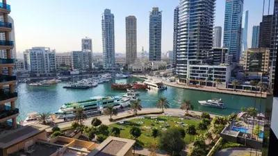 a view of a river with boats in a city at Sparkle Tower by Swarovski, Premium Full Marina View, 2min JBR & Metro, Sleeps 4 in Dubai
