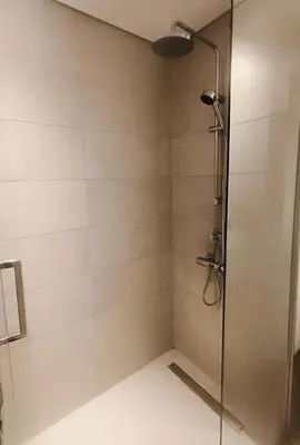 a shower stall with a glass shower door at Fully furnished studio with amenities in Dubai in Dubai