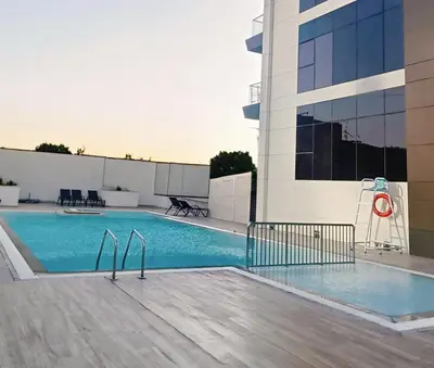 a swimming pool on the roof of a building at Fully furnished studio with amenities in Dubai in Dubai
