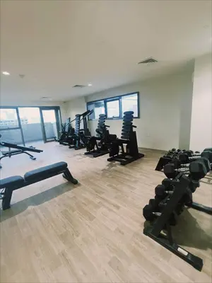 a gym with rows of treadmills and machines at Fully furnished studio with amenities in Dubai in Dubai