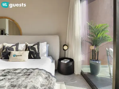 a bedroom with a white bed and a window at HiGuests - High Rise Studio Haven in Business Bay in Dubai