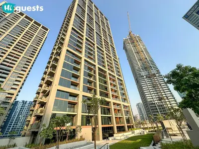 two tall buildings with palm trees in front of them at HiGuests - High Rise Studio Haven in Business Bay in Dubai
