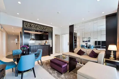 a living room with a couch and a table at Refined 1 bedroom - Upper Crest - Near Dubai Mall in Dubai