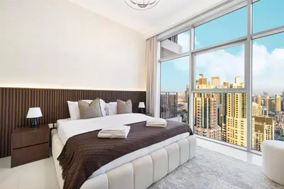 a bedroom with a large bed and a large window at Spacious Lux 4 Bed with Large Balcony and Burj View by Vista Stays Dubai in Dubai