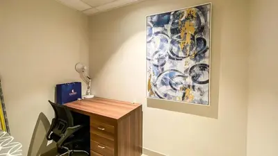 a room with a desk and a painting on the wall at 1BR Study luxury Furnished Utilities Included DXB in Dubai